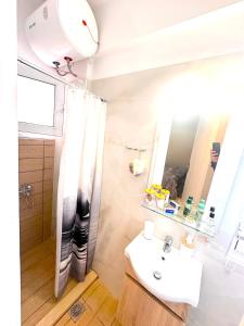 a bathroom with a sink and a shower at Argiro's apartment in Mytilene +11 photos