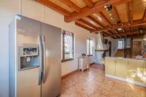 a kitchen with a stainless steel refrigerator in a room at Casa la Encina de Pancar in Pancar