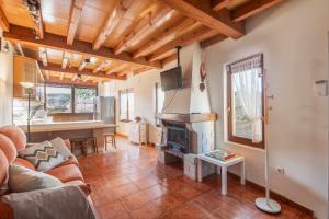 a living room with a couch and a fireplace at Casa la Encina de Pancar in Pancar