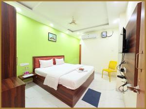 - une chambre dotée d'un lit avec un mur vert dans l'établissement Baliapand Road NewParwati Palace Inn- #Fully Air Condition with All Luxury Luxuary Rooms #Balcony Free Wifi # Parking & Lift Facilities- Best Luxuary Hotel In Puri, à Purî