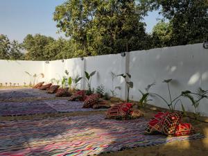 a row of pillows are lined up against a wall at Nakhil Pyramids Resort in Cairo
