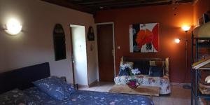 a living room with a couch and a table at La Chambre des Buissonnats in Martailly-lès-Brancion +28 photos