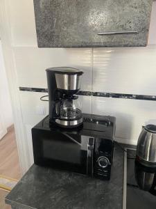 a coffee maker sitting on top of a counter at Apartments Angels o k b in Altenburg