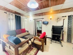 a living room with a couch and a tv at Dhana Breeze in Weligama