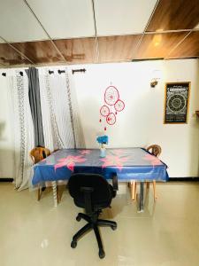 a table with a chair in a room at Dhana Breeze in Weligama +13 photos