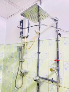 a shower with a light on a wall at Dhana Breeze in Weligama