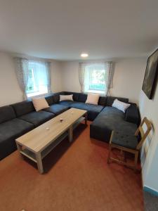 a living room with a couch and a coffee table at Chata Luisa in Nová Komora