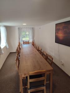 a conference room with a wooden table and chairs at Chata Luisa in Nová Komora