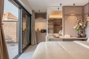 a bedroom with a view of a kitchen and a bed at Luxe Guestroom free bikes and parking in Bruges