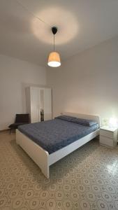 ein Schlafzimmer mit einem großen Bett und einer Lampe in der Unterkunft Faenza Apartments by Console Camprini Estates srl in Faenza