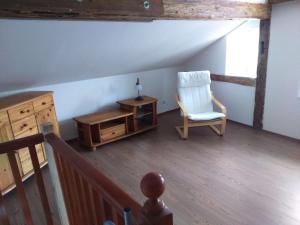 an attic room with a chair and a table at Jurahaus Solnhofen in Solnhofen
