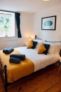 a bedroom with a large bed with pillows on it at The Quaker Hall - Private Deck - Stunning Views in Falmouth