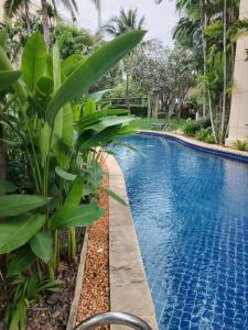 a swimming pool at a resort with a large blue pool at Hua Hin Blue Lagoon Island Villa A Family Paradise in Ban Nong Chaeng