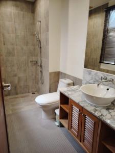 a bathroom with a sink and a toilet and a shower at Hua Hin Blue Lagoon Island Villa A Family Paradise in Ban Nong Chaeng