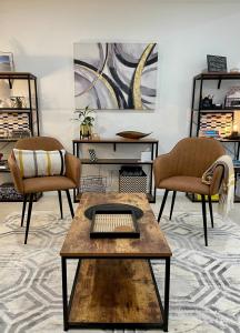 a living room with two chairs and a coffee table at La Chaumiere - Charm and character in leafy green suburb in Caboolture