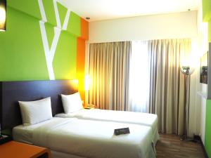 a hotel room with two beds and a window at Prescott Ace Kuala Lumpur Cheras in Kuala Lumpur