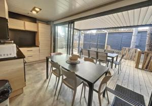 a kitchen and dining room with a table and chairs at Le Cottage de Laura Jullouville 6 pers in Jullouville-les-Pins