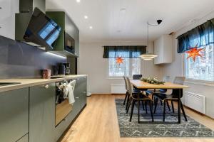 Una cocina con una mesa y sillas en una habitación. en Villa Lapland Luxe, Private Sauna, Free Wifi, en Rovaniemi