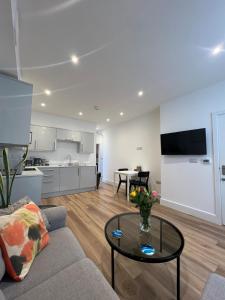 a living room with a couch and a table at 1 Bed Apartment in Town Centre in Newquay +3 photos