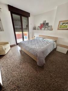 Un dormitorio con una cama y una ventana grande en OndaUrbana, en Lecce