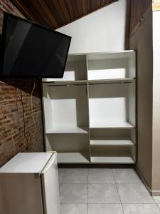 a refrigerator with a tv on top of it at Hotel Fazenda Haras RD in Olímpia +44 photos