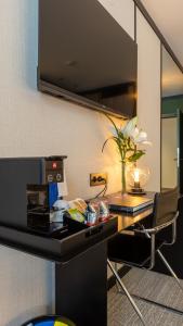 a room with a counter with a table and a chair at Roc Blanc Hotel & Spa in Andorra la Vella