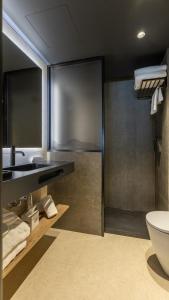 a bathroom with a sink and a toilet at Roc Blanc Hotel & Spa in Andorra la Vella +152 photos