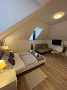 a bedroom with a bed and a living room at Budapest Airport Almáskert Panzió in Vecsés