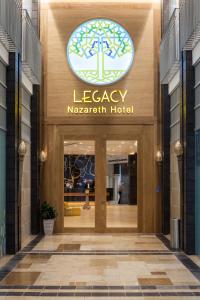 a building with a sign that reads leacy magellan hotel at Legacy Hotel ַ& Convention Center Nazareth in Nazareth