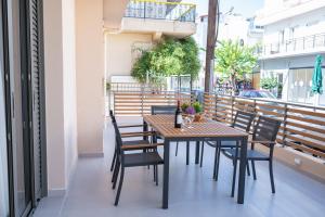 a wooden table and chairs on a balcony at Michail Old Harbour Residence in Kos