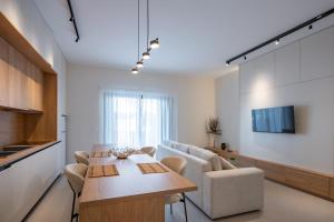 a living room with a table and a couch at Michail Old Harbour Residence in Kos