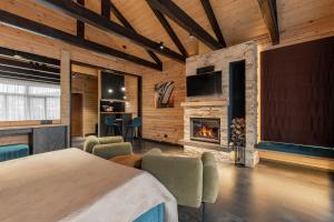 a bedroom with a bed and a fireplace at Equides club in Lesniki