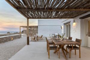a dining room with a wooden table and chairs at New Project Fos in Platis Yialos Sifnos