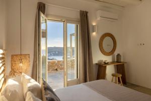 a bedroom with a bed and a view of the ocean at New Project Fos in Platis Yialos Sifnos +122 photos