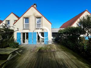 ein Haus mit blauen Türen auf einer Holzterrasse in der Unterkunft COC - Basse Mer in Wissant