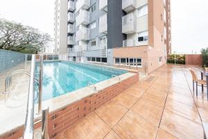 a swimming pool on the side of a building at BHomy Romana in Sao Paulo