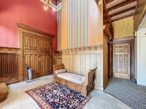 a living room with a chair and a rug at Le Toit Sahler-Château Sahler XXᵉ in Exincourt