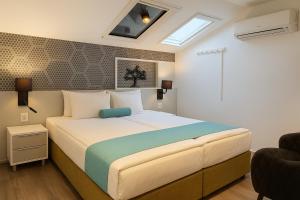 a bedroom with a large bed in a room at Hotel Mika Downtown in Budapest +65 photos