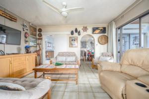 a living room with a couch and a table at Beachcomber Bay Guest House In South Africa in Margate