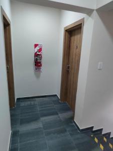 圣地亚哥-德尔埃斯特罗Departamento Centrico Santiago piso 1 Y 2的空的走廊,有两扇门,铺着瓷砖地板