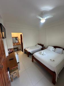 Ένα ή περισσότερα κρεβάτια σε δωμάτιο στο Pousada Acqua Azul