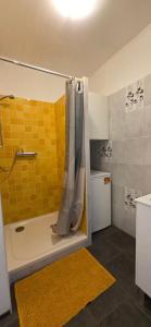 a bathroom with a shower with a shower curtain at Apartmán v centre mesta Žilina in Žilina