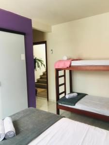 a room with two bunk beds and a mirror at Pousada Nova Trilha in Palhoça