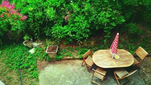 an overhead view of a wooden table and chairs with an umbrella at Caregli Countryhouse in Borzonasca