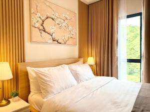 a bedroom with a white bed and a window at The Banyan Rest in Balibaguhan