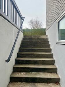 a set of stairs next to a building at Stenkällan - snabbuss 5 in Malmö