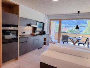 a bedroom with a bed and a dining room with a table at Haus Fontanas by Emju - Vandans in Vandans