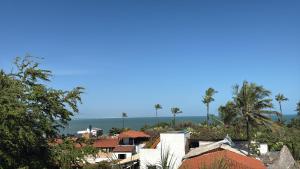 a view of a city with palm trees and the ocean at Pousada Beleleuss in Jericoacoara