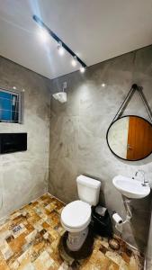 a bathroom with a toilet and a sink at Riacho Hotel in Brasilia