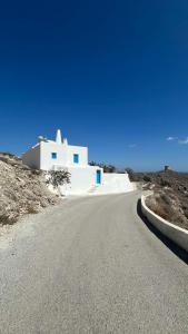 an empty road in front of a white building at Yposkafon Concept Two-Bedroom Villa with Private Jacuzzi and Hamam in Megalokhori